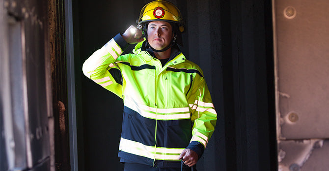 Image of a firefigher wearing the Tactix Hi-Vis Parka.