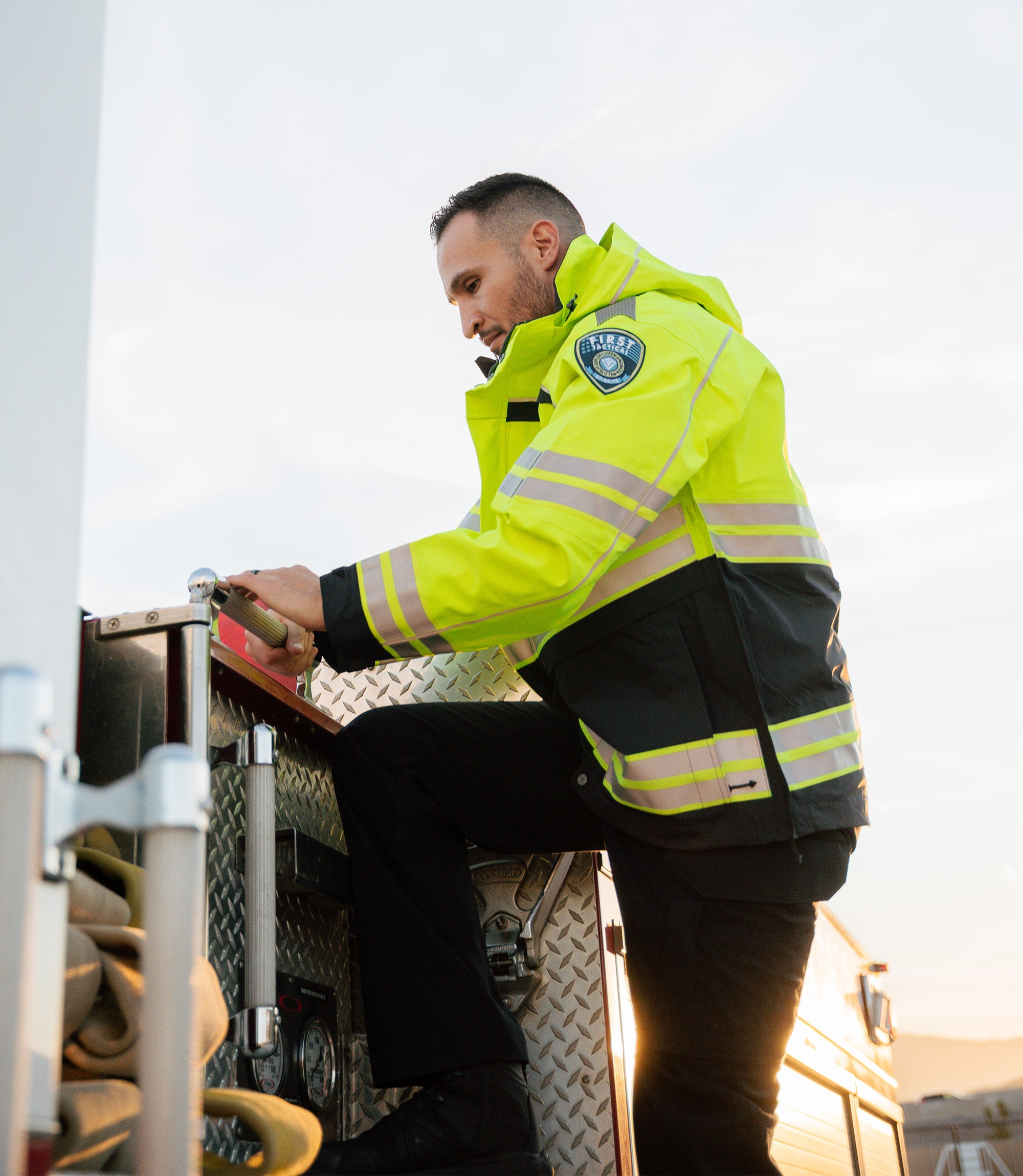 Men in Tactix Hi-Vis Parka Outer Shell jacket on a fire truck |color_midnight navy