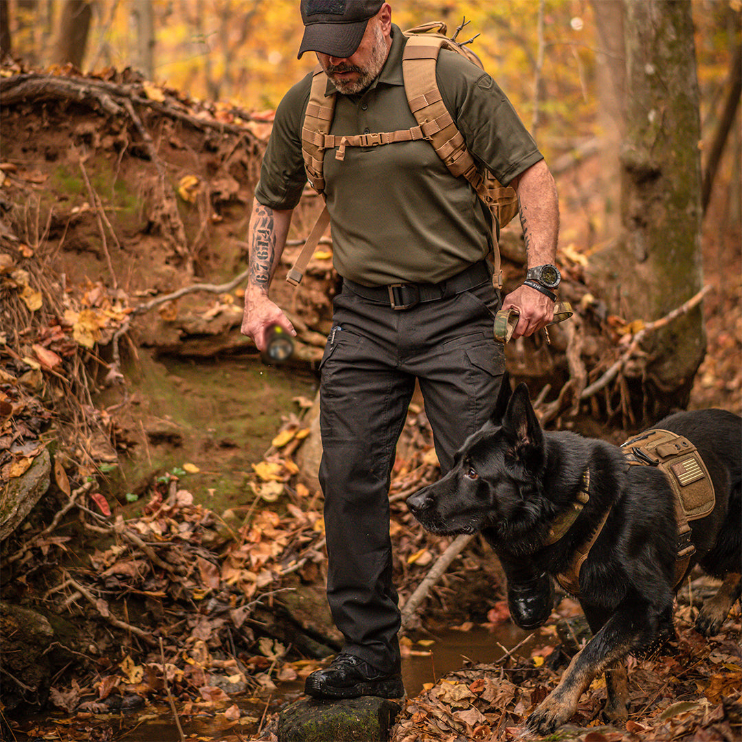 Image of a man and a dog out in the forest